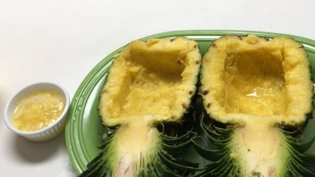 Cut the pineapple in half and leave the stem intact like this